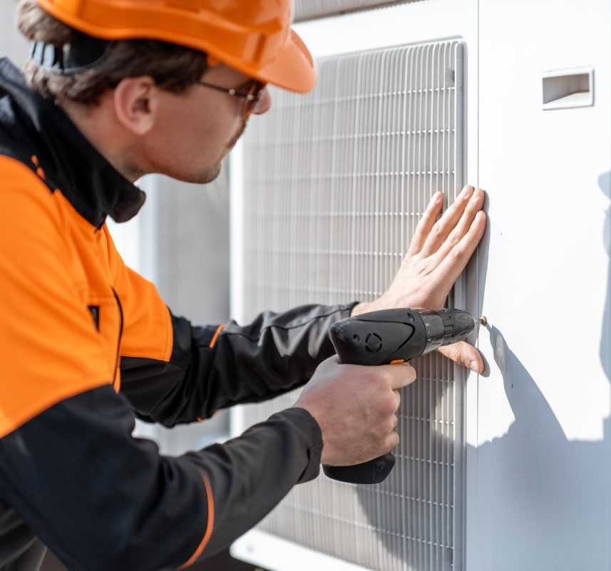 installing a heat pump worker installing a heat pump